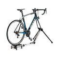 Minoura FG220 hybrid roller bike trainer with road bike, folded position and storage bag